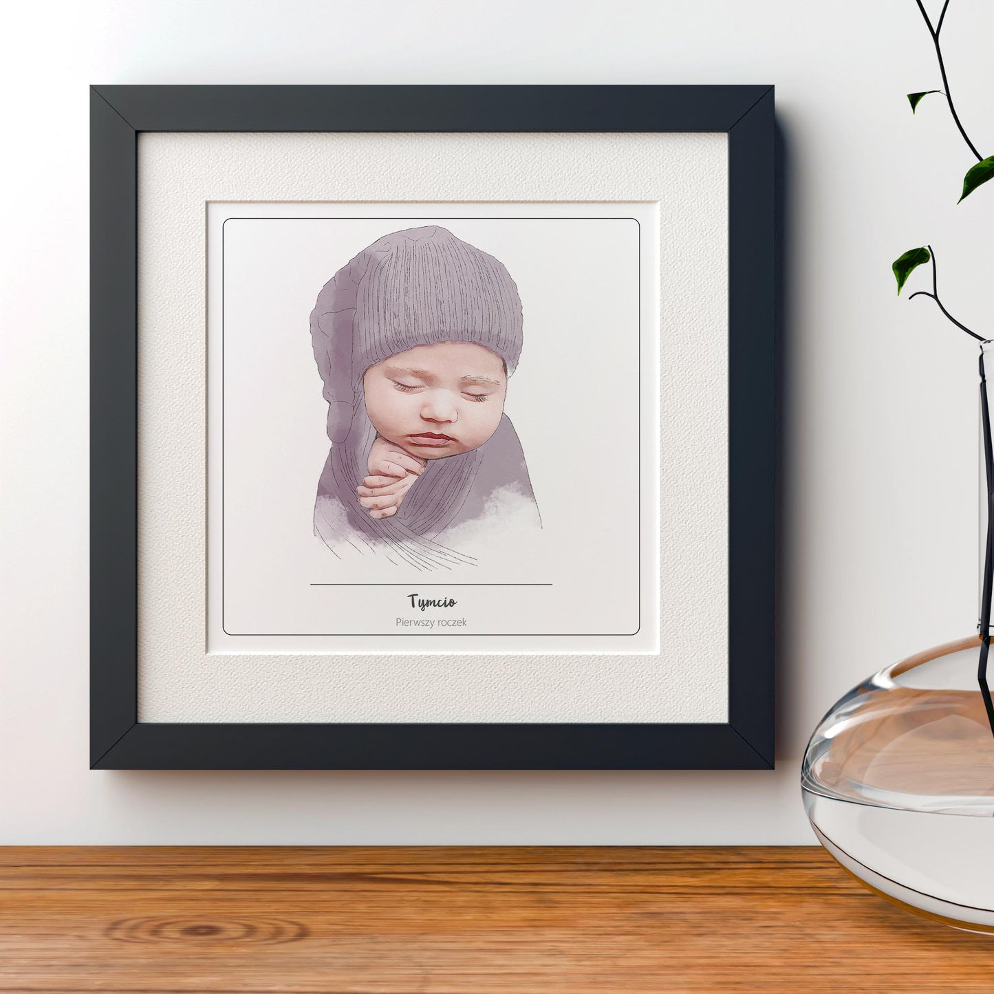 portret dziecka, niemowlaka oprawiony w czarną ramę. Portret w stylu akwarelowym